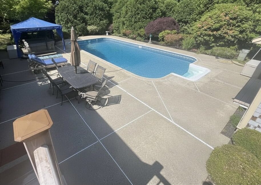 Clean concrete pool deck after pressure washing in the South Shore